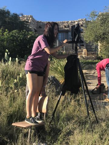 Student takes a picture with a large camera