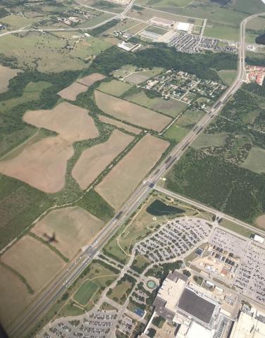 Areial view of roads, development and farm plots in Austin