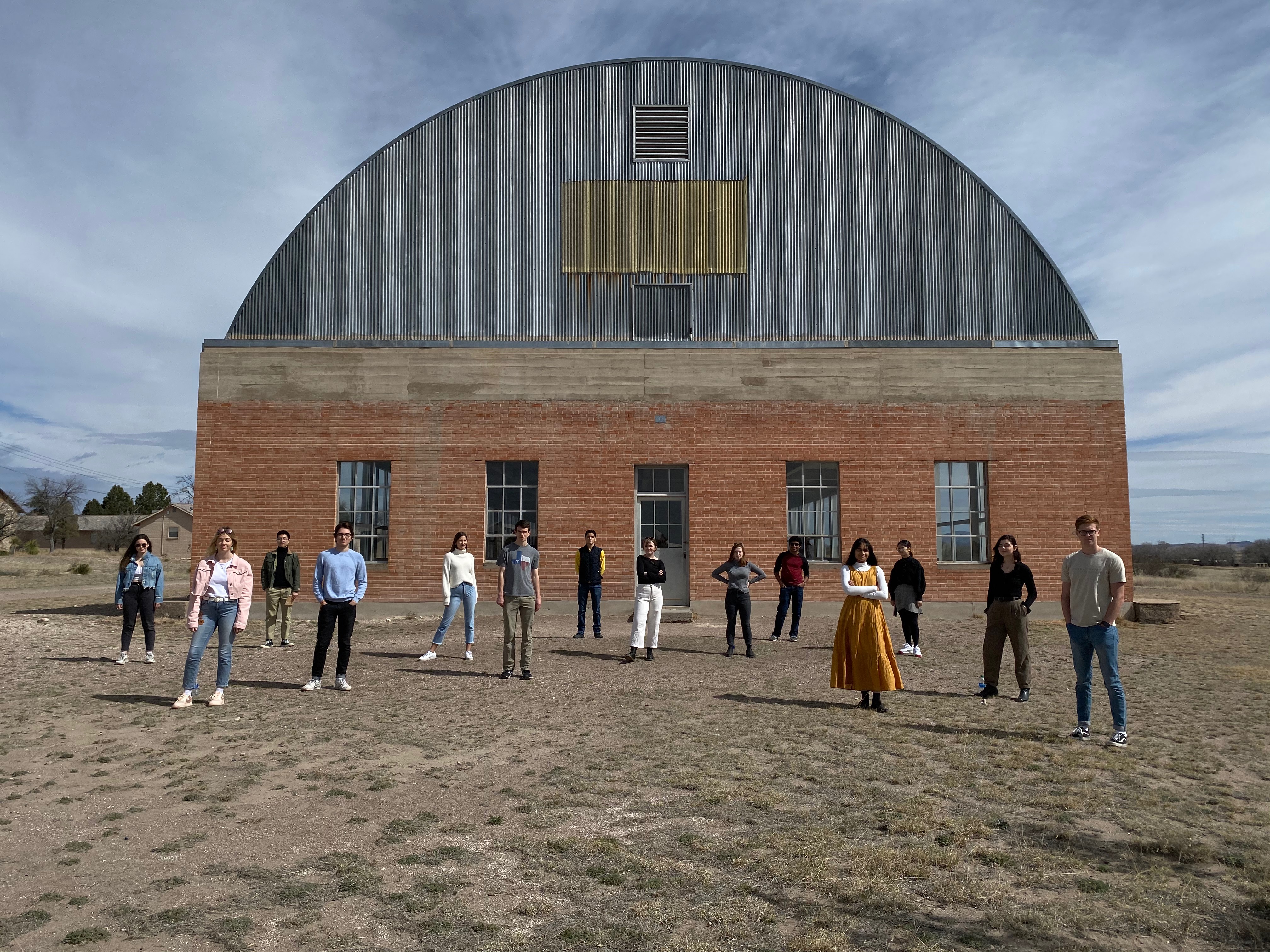 Students standing interspersed in front of a round-topped building in West Texas