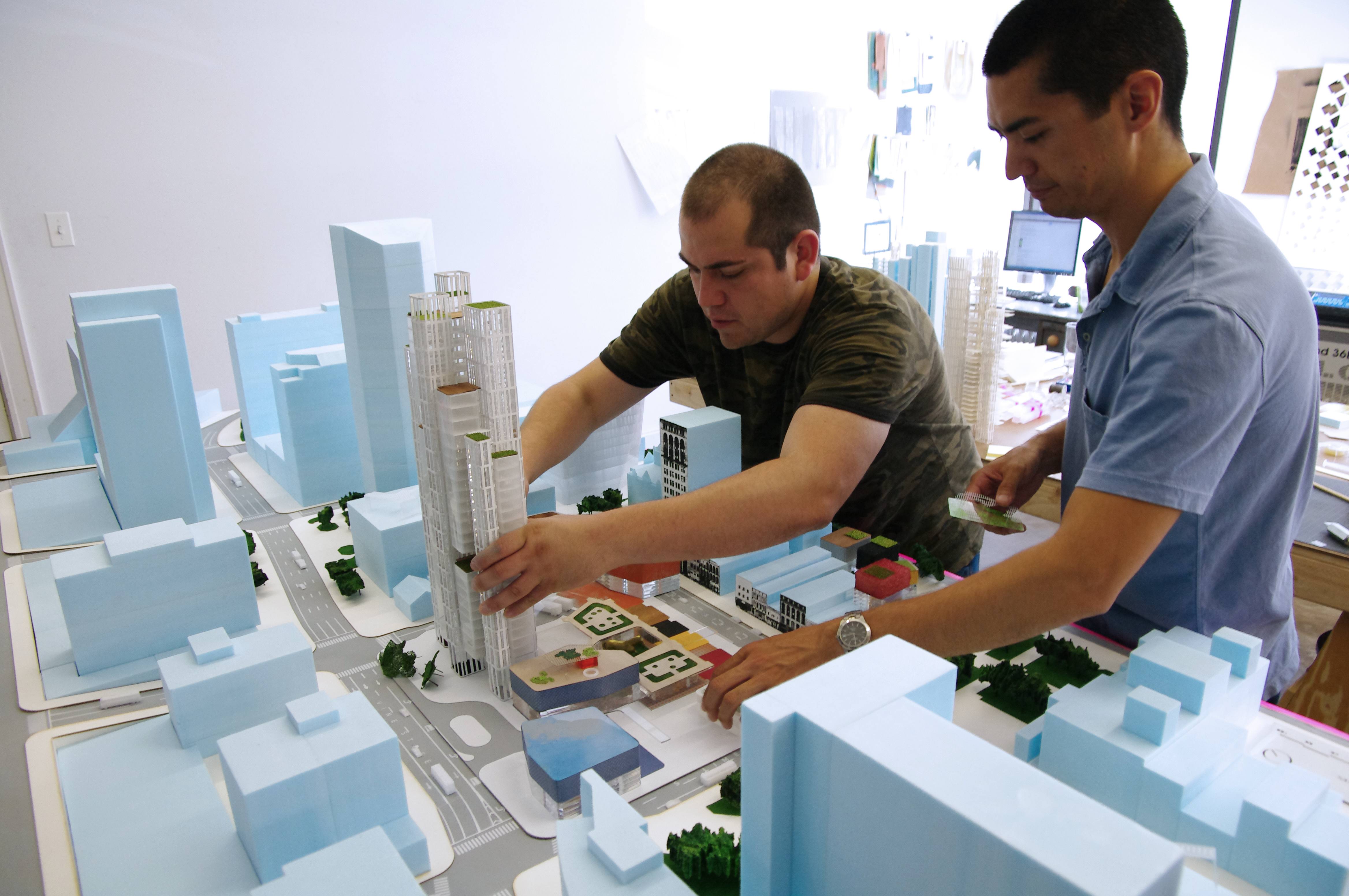 Professional Residency Student interacting with an architecture model while on his residency