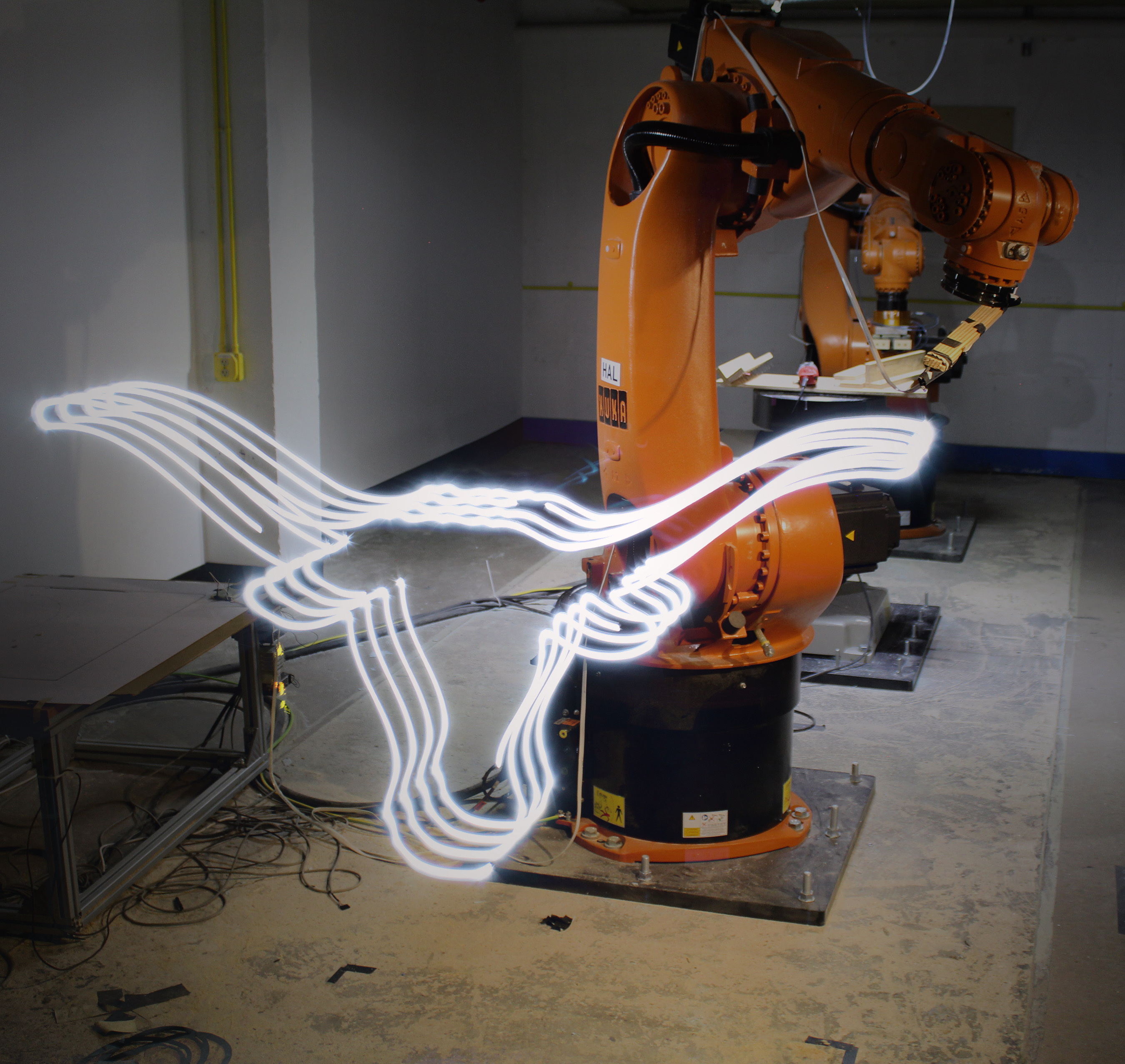 The longhorn symbol shown in front of a KUKA robotic arm