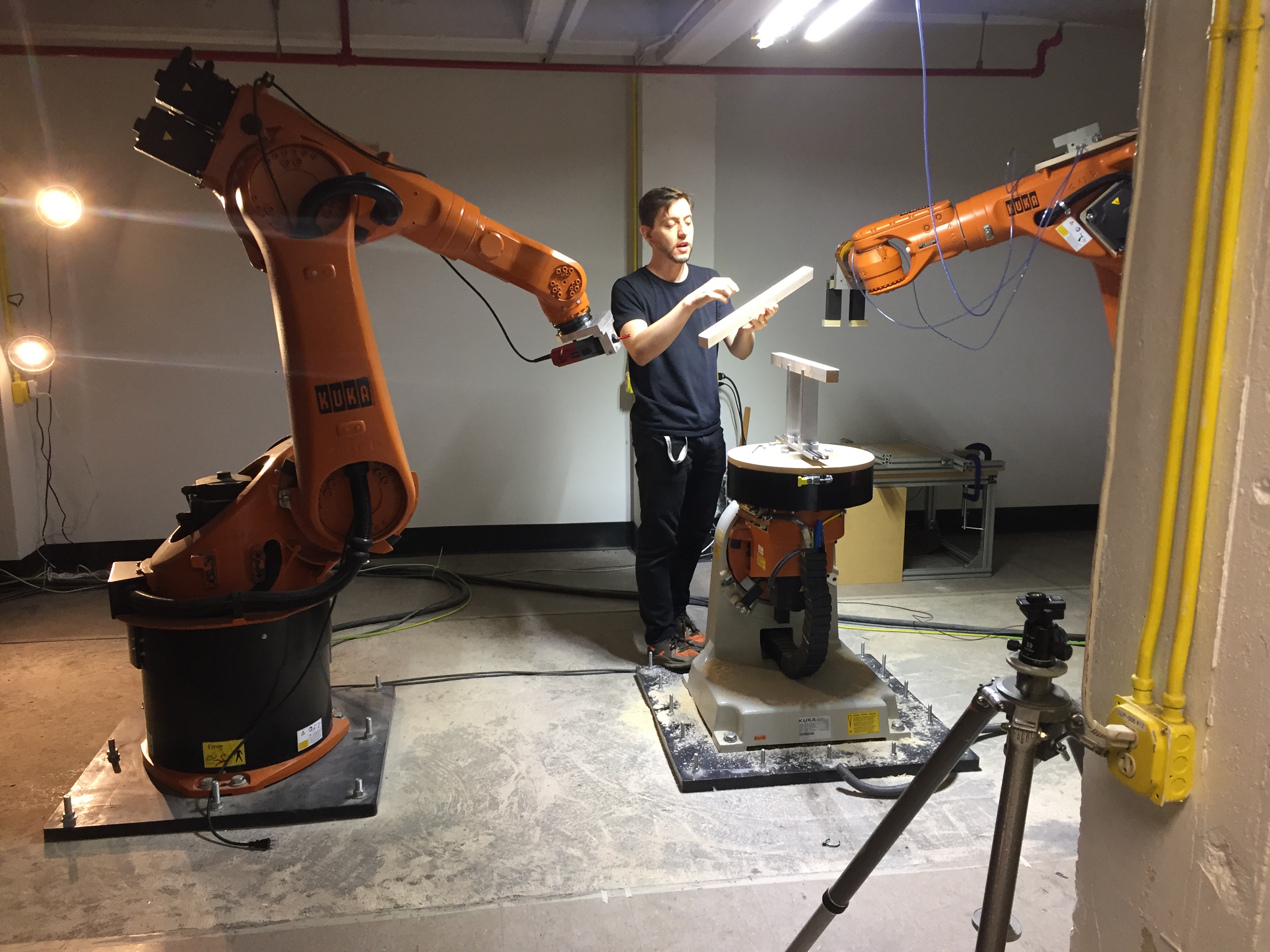 Student interacting with the school's two KUKA robotic arms