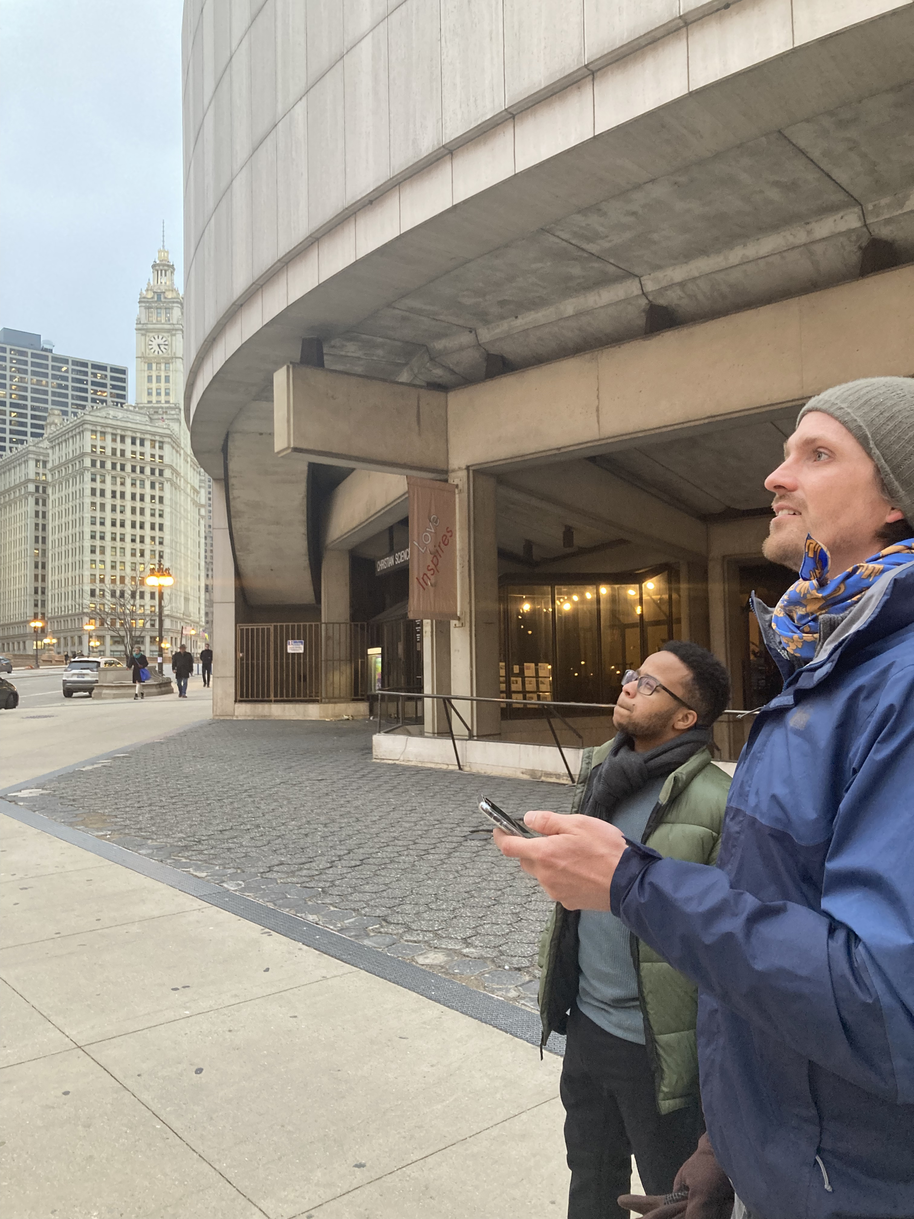 Two students looking up in front of a downtown Chicago building