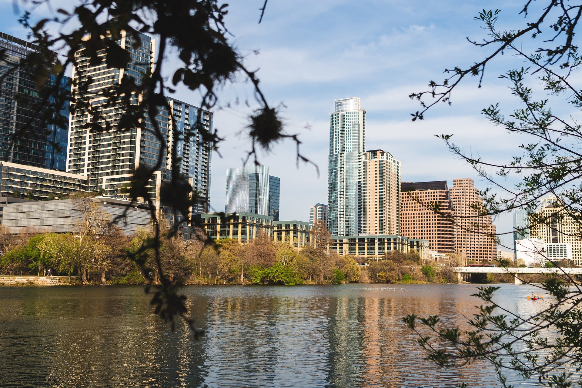 Downtown Austin skyline seen through the trees along Lady Bird Lake