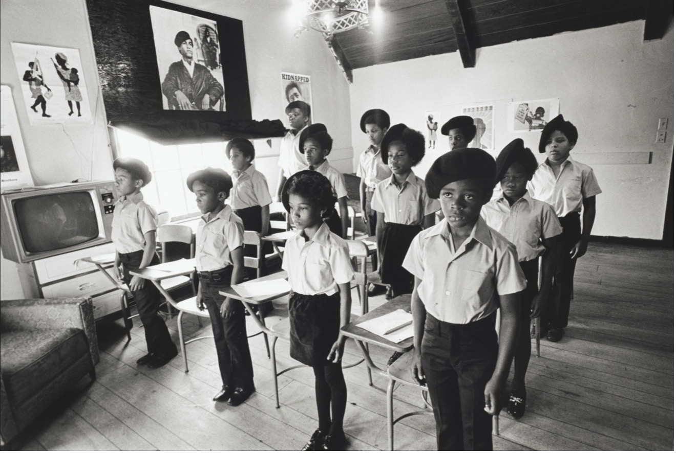 Black and white photo of Black Panther children in a schoolhouse
