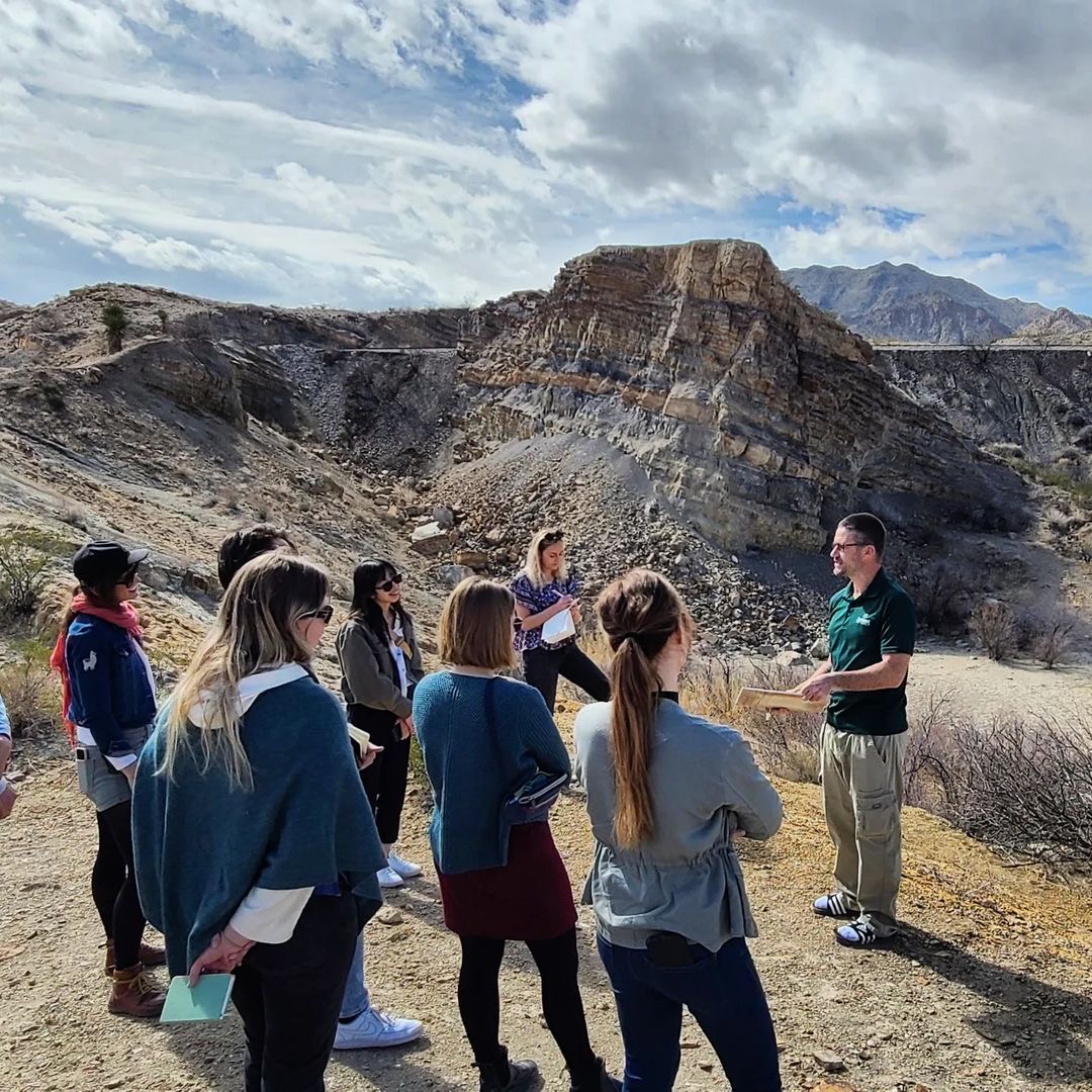 Landscape architecture students conducting field work in El Paso in front of a mountainous rock formation