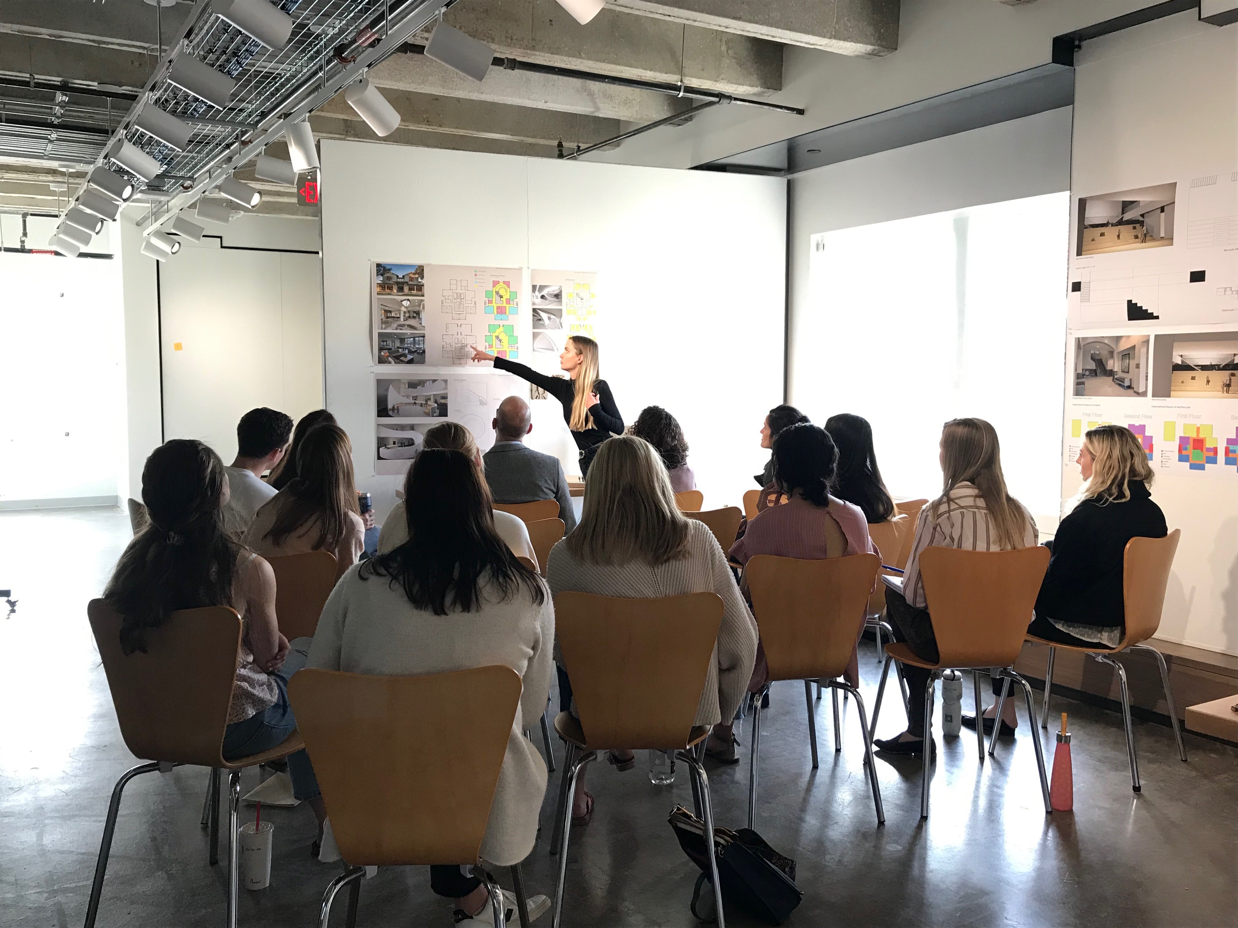 An interior design student presenting during final reviews