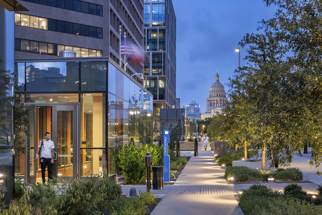 View of the Texas State Captiol through the Capitol Mall at dusk.