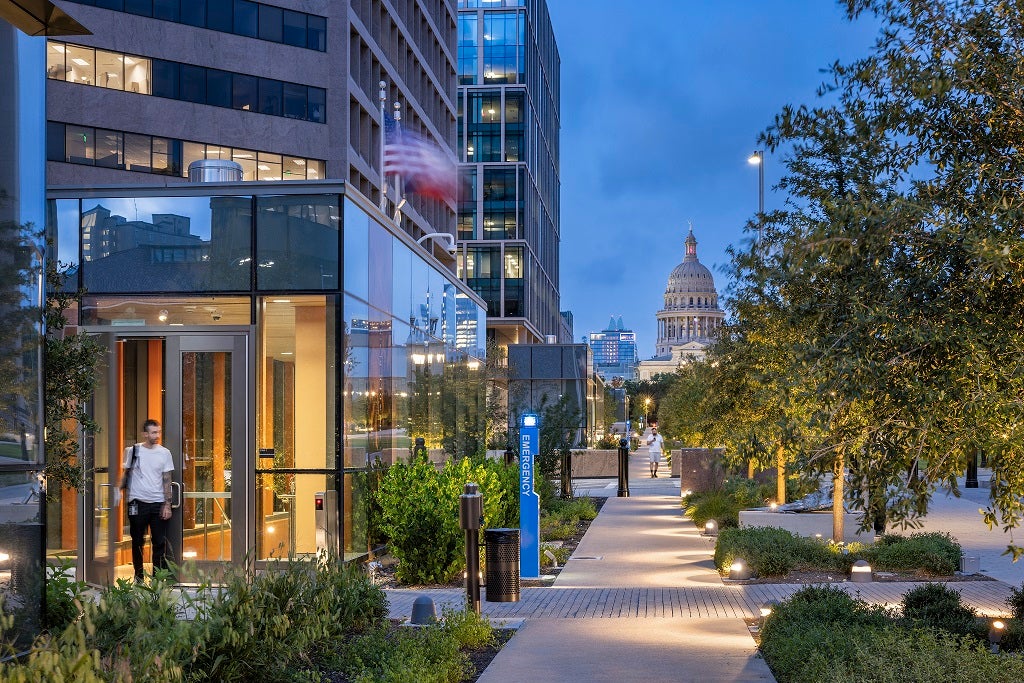 View of the Texas State Captiol through the Capitol Mall at dusk.