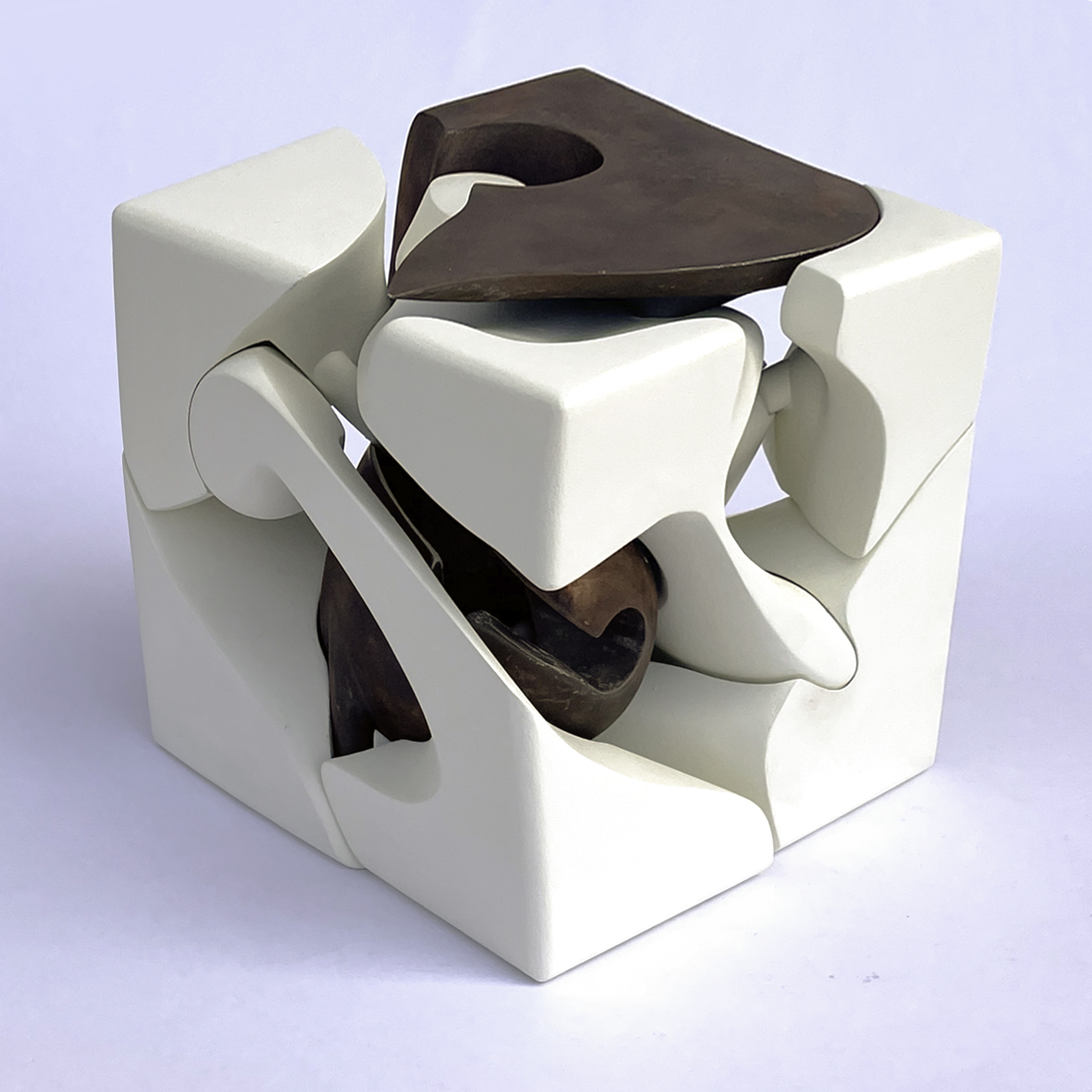 A complex 3D puzzle comprised of large geometric white and brown pieces.