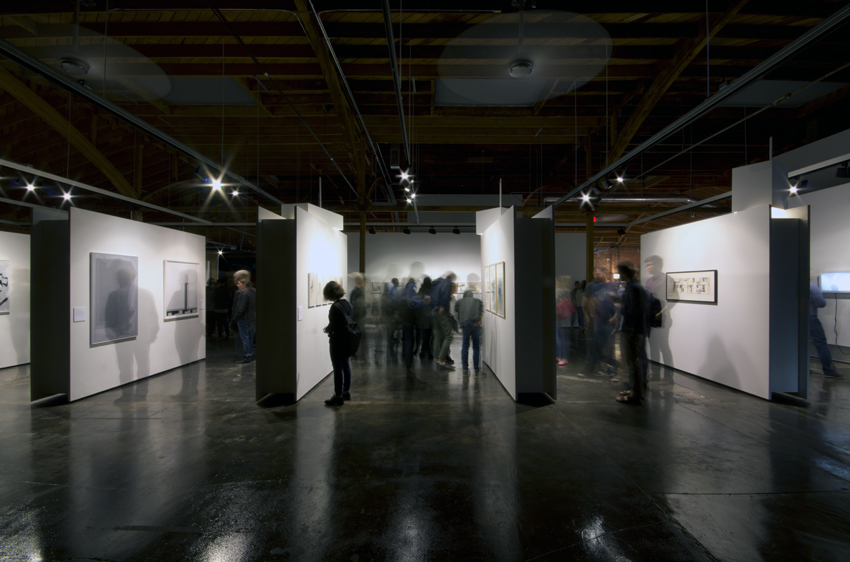 People looking at an exhibition in a dark space