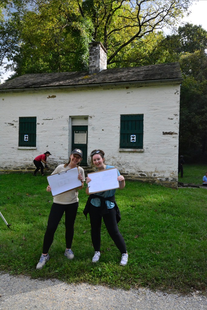 Students holding their sketchbooks in front of a historic building
