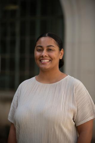 Anita stands smiling for a headshot photo