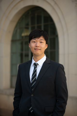 Seunggwan smiles at the camera for a headshot photo