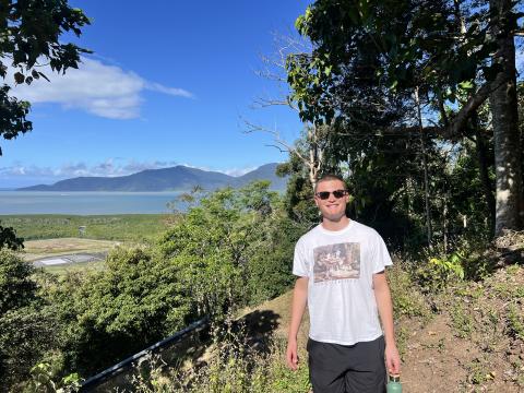 aaron stands in a photo smiling along an australian trail