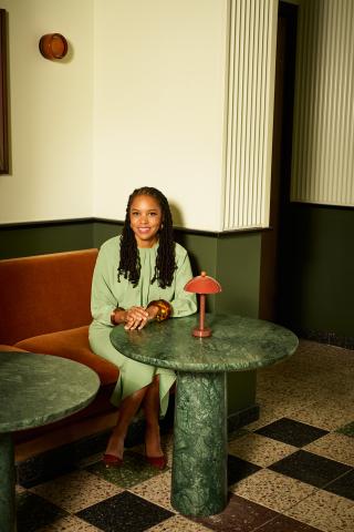 Photo of Little Wing Lee sitting at a marble table