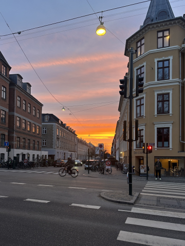 sun setting in a downtown area of copenhagen