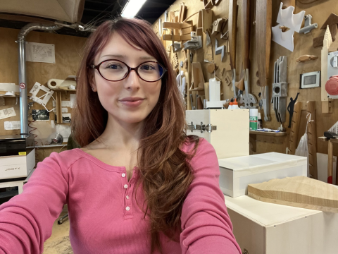 photo of gabriela fuentes in a pink shirt at work