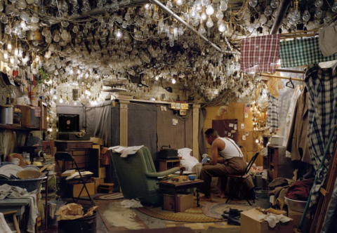 Photo of a space with lights and photos hanging up 