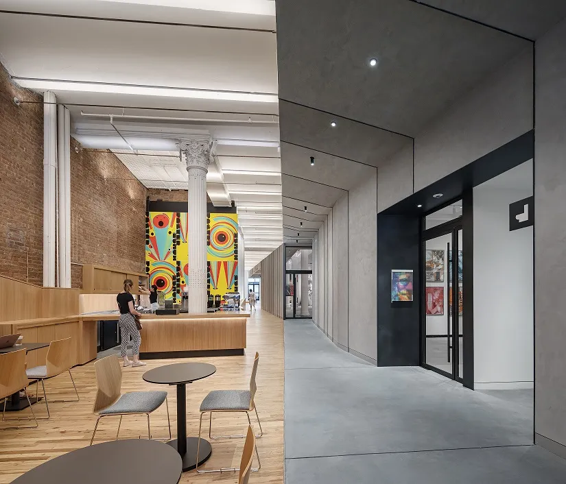 Two hallways set side-by-side. On the left, a warm, wooden space with chairs and overhead lights. On the right, a darker hallway.