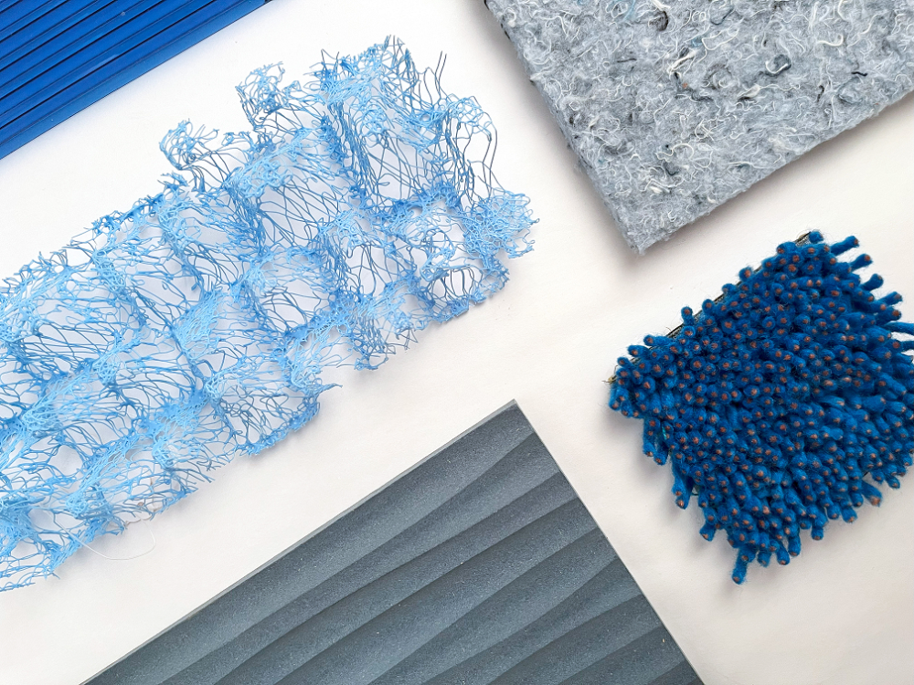 various materials in different shades of blue laid out on a white table seen from above