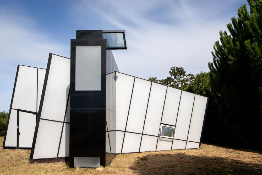 Black and white house comprised of rectangular shapes at different angles.