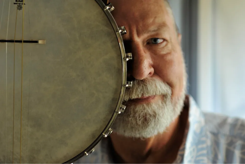 Artistic image of Mike Farmer behind his banjo.