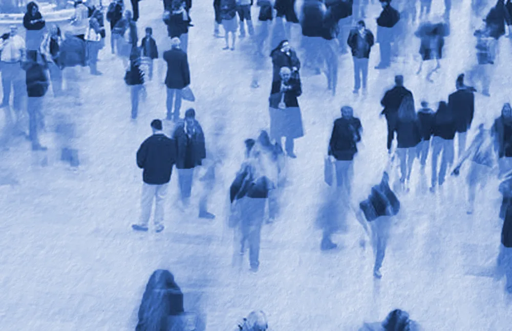 Blurred image of people walking in a crowded space
