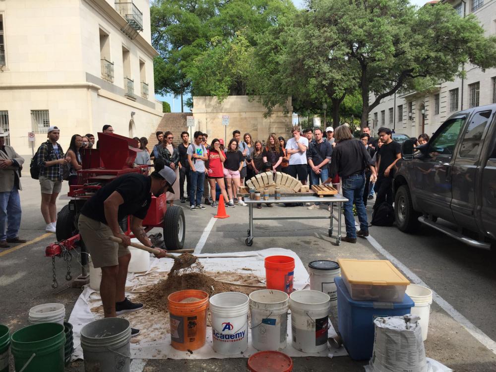 Preparation of the soil to be used for CEBs while Jim shows arch to students. 