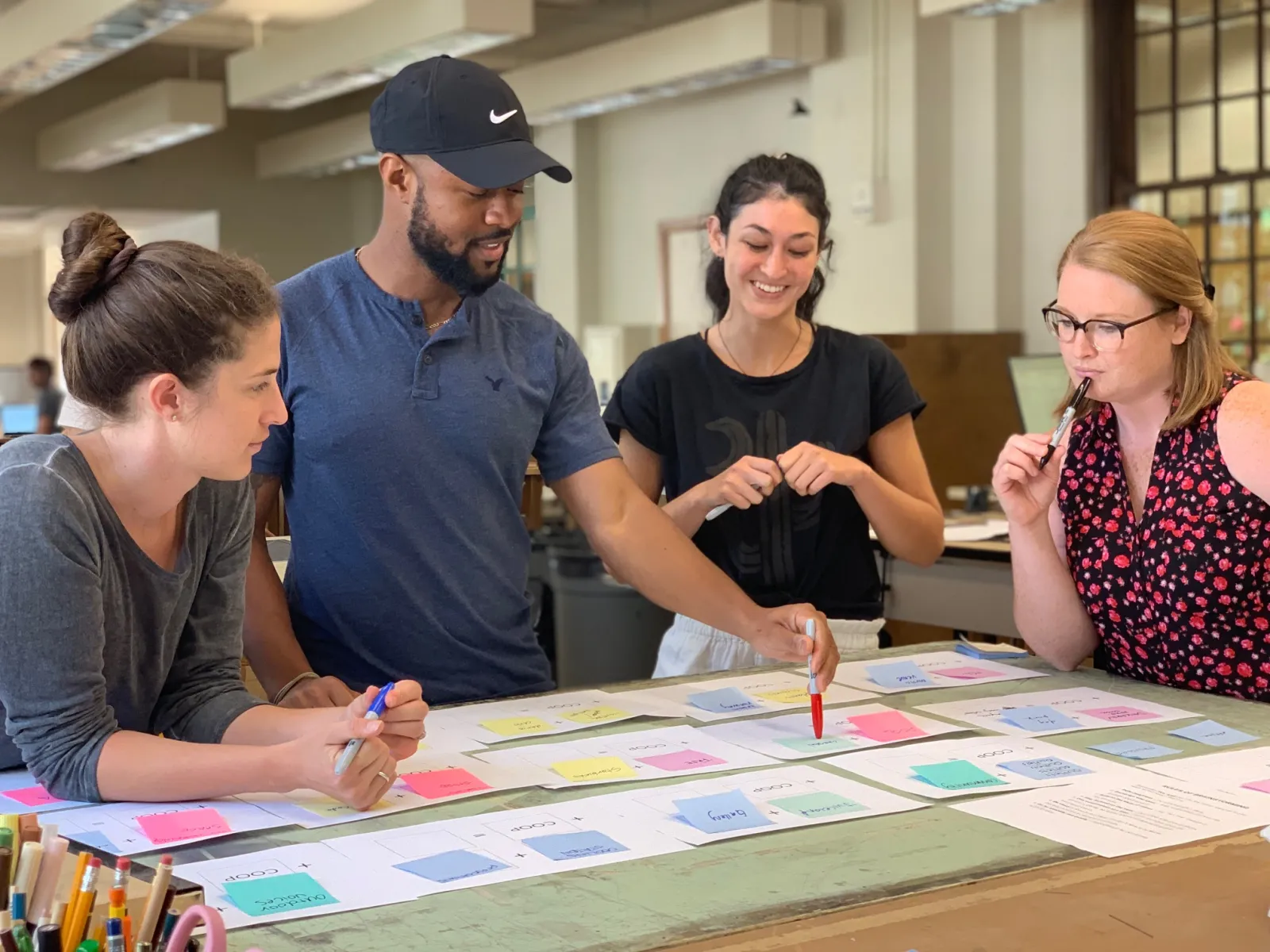 Students reviewing designs on a desk