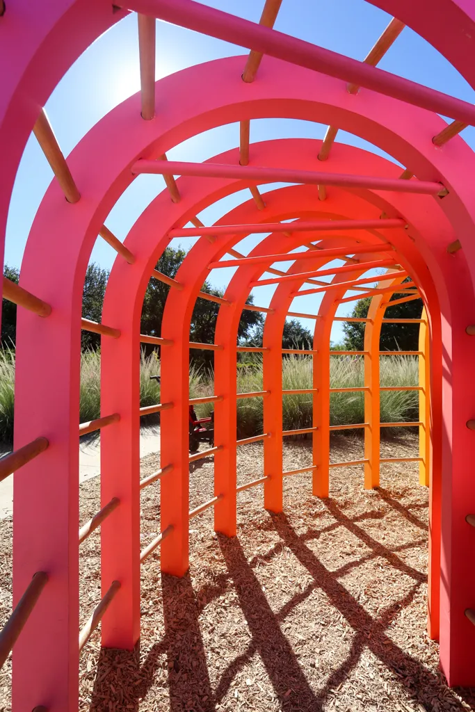 Photo of the interior of Monkey Bar Fort, looking through the colorful arches as shadows fall in interesting ways.