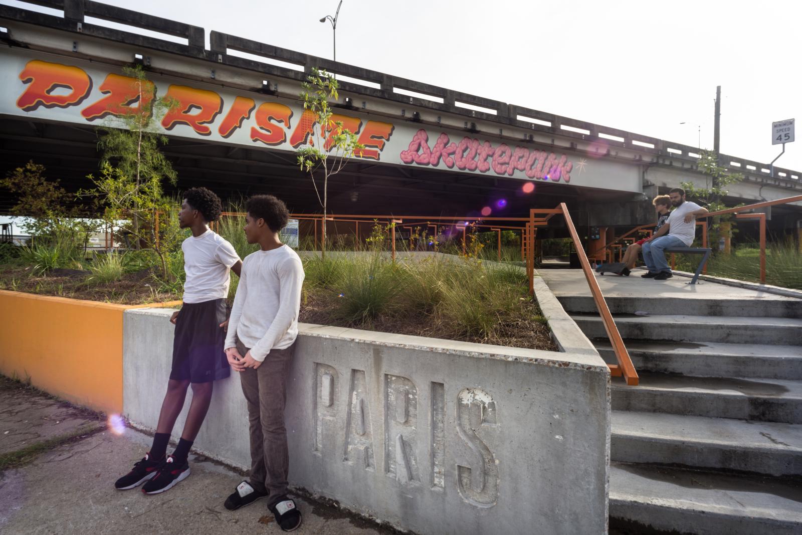 Two boys leaning against a concrete wall at the Parasite Skate Park in New Orleans