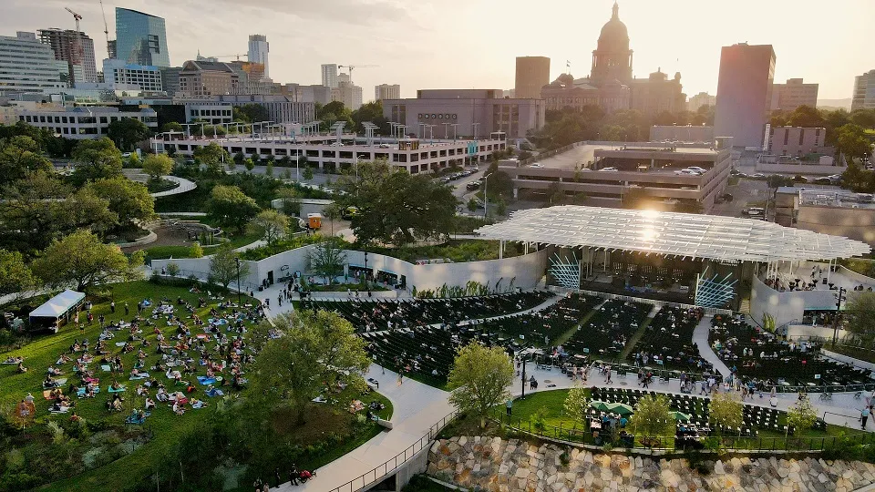 Aerial shot of Waterloo Park during an event with downtown Austin in the background.