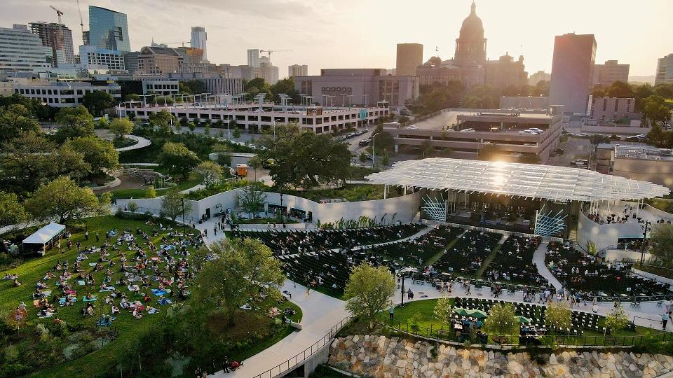 Aerial shot of Waterloo Park during an event with downtown Austin in the background.