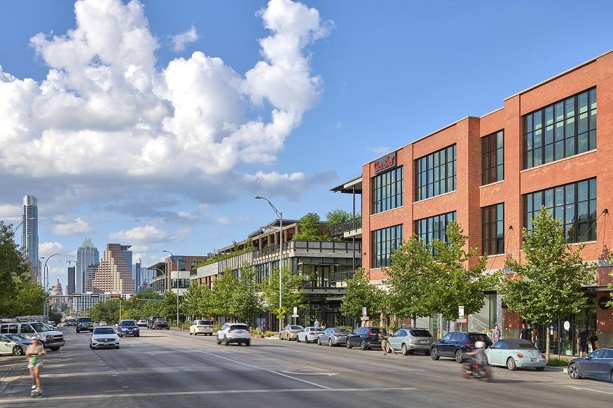 View of South Congress looking forwards the Texas State Captiol on a sunny day, with Music Lane on the right