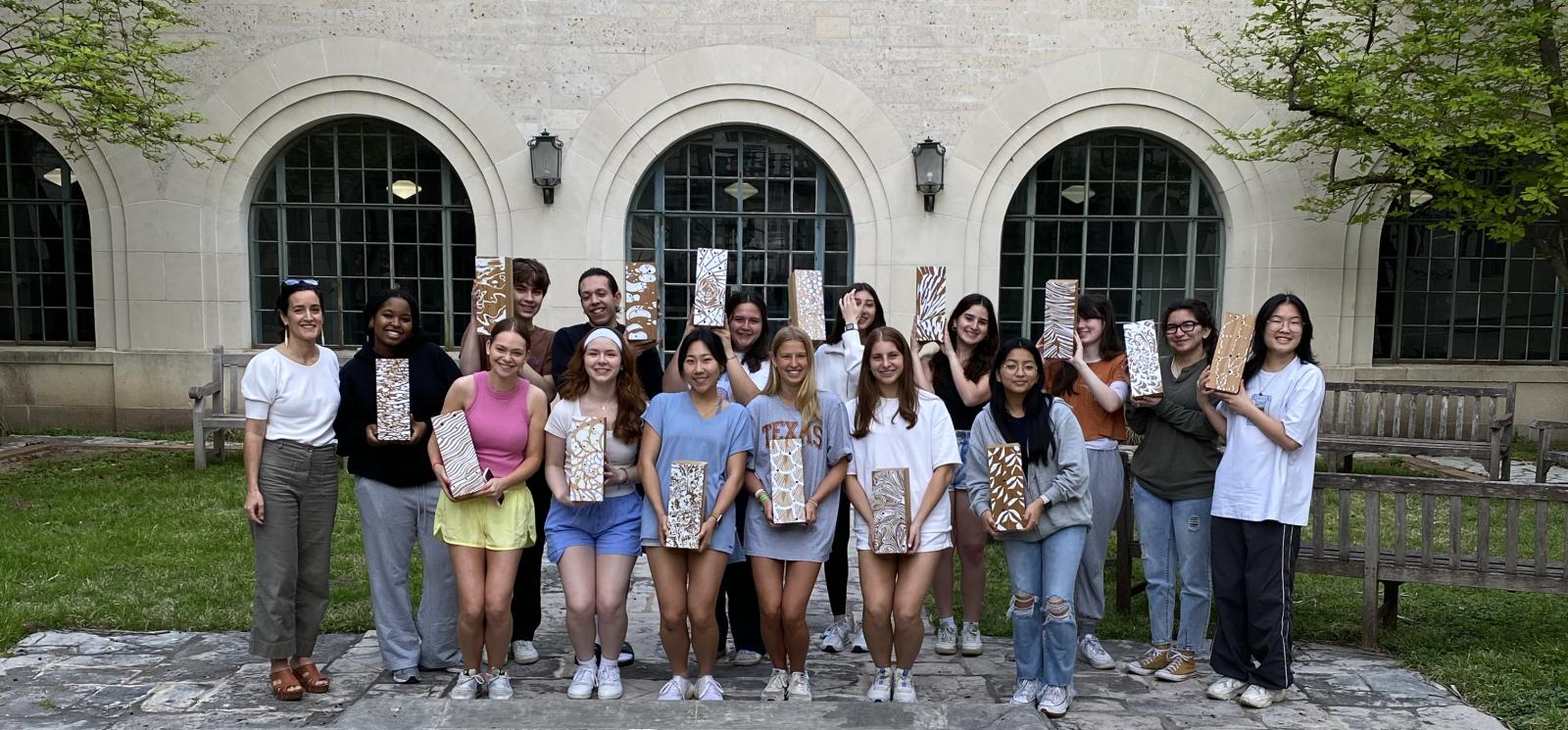 Group shot of Nerea Feliz and her interior design students in the Goldsmith Courtyard with their insect habitats.