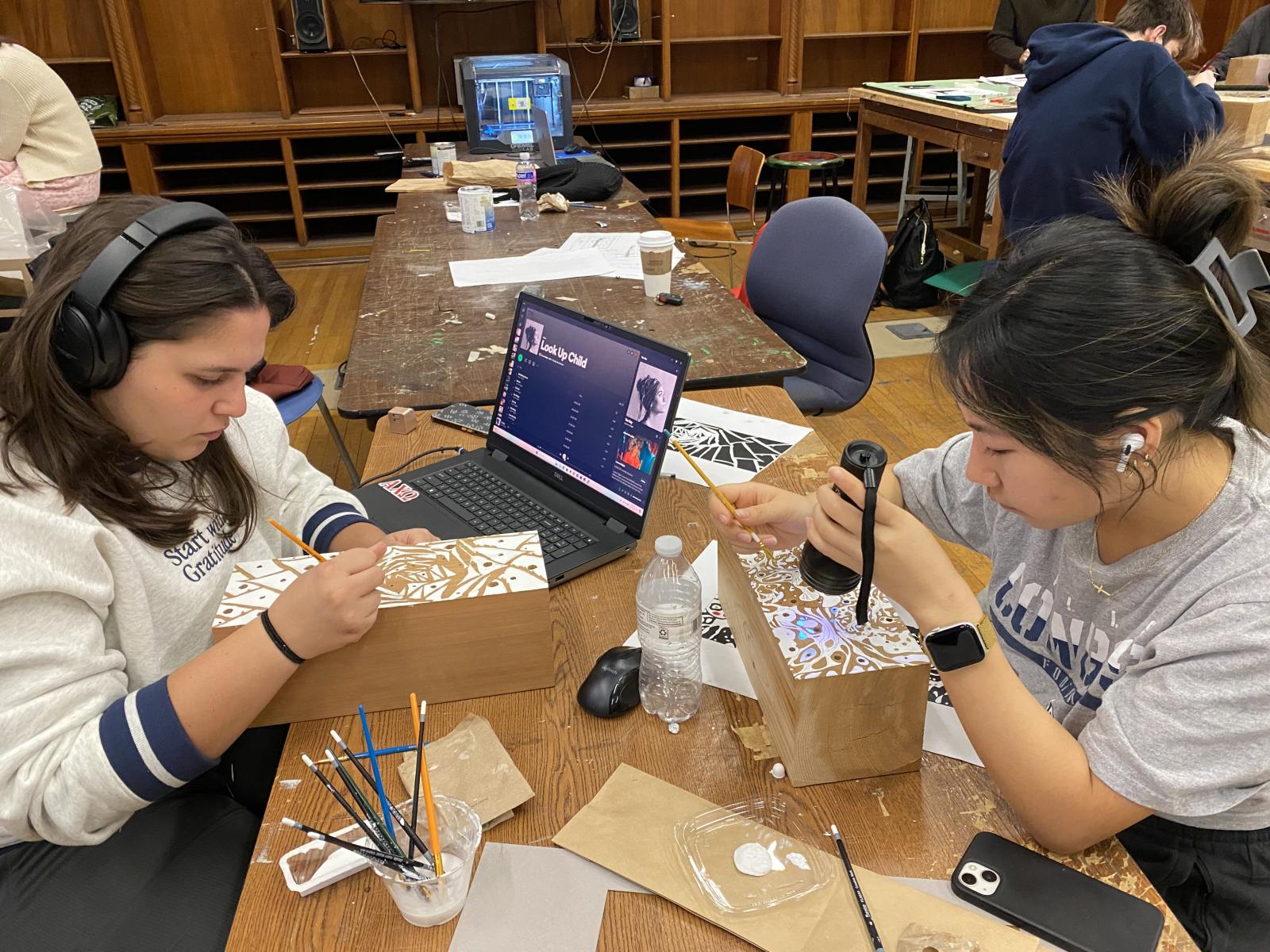 Interior design students working in studio on their insect habitats.