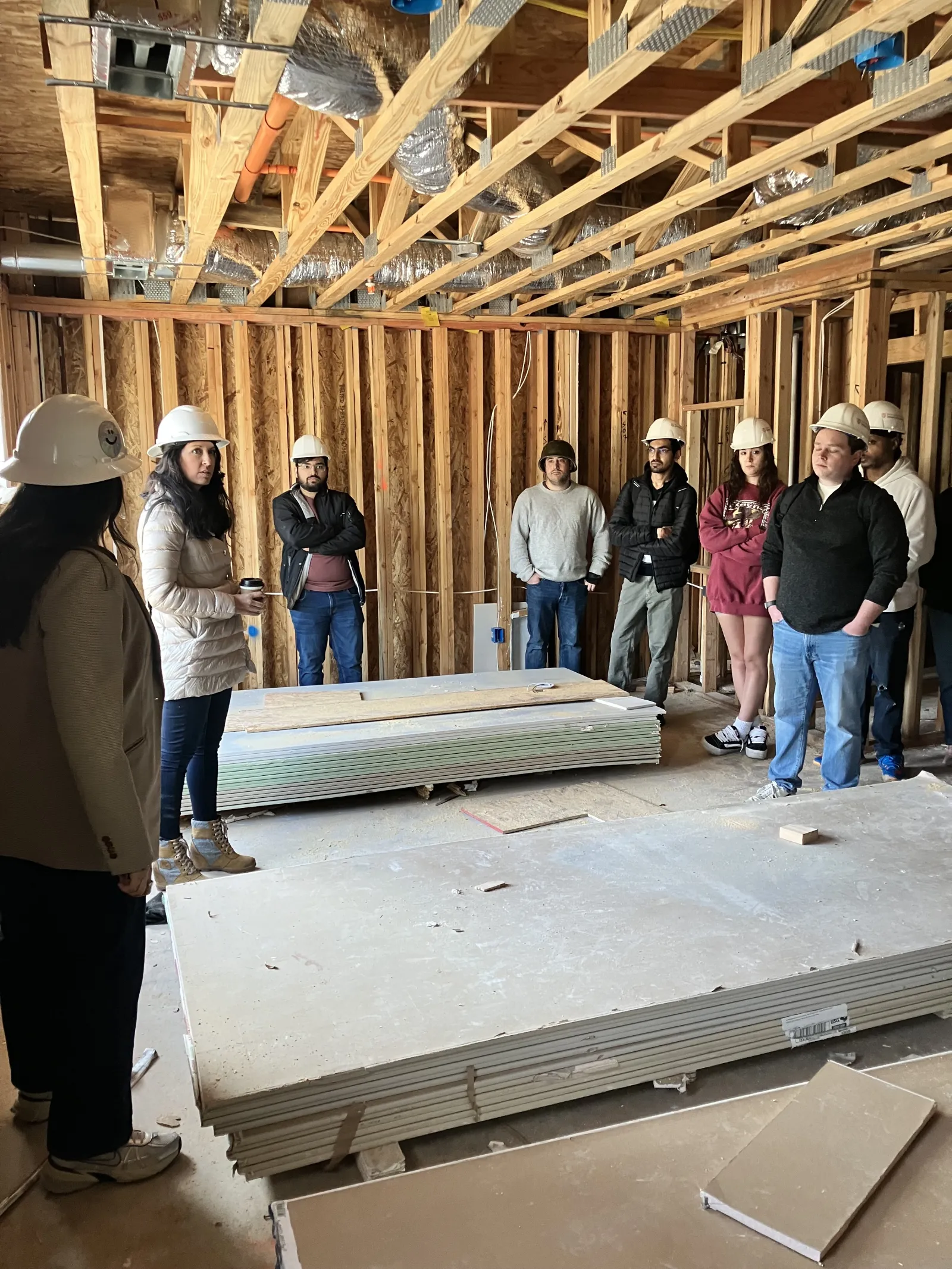 group of people inside a building under construction