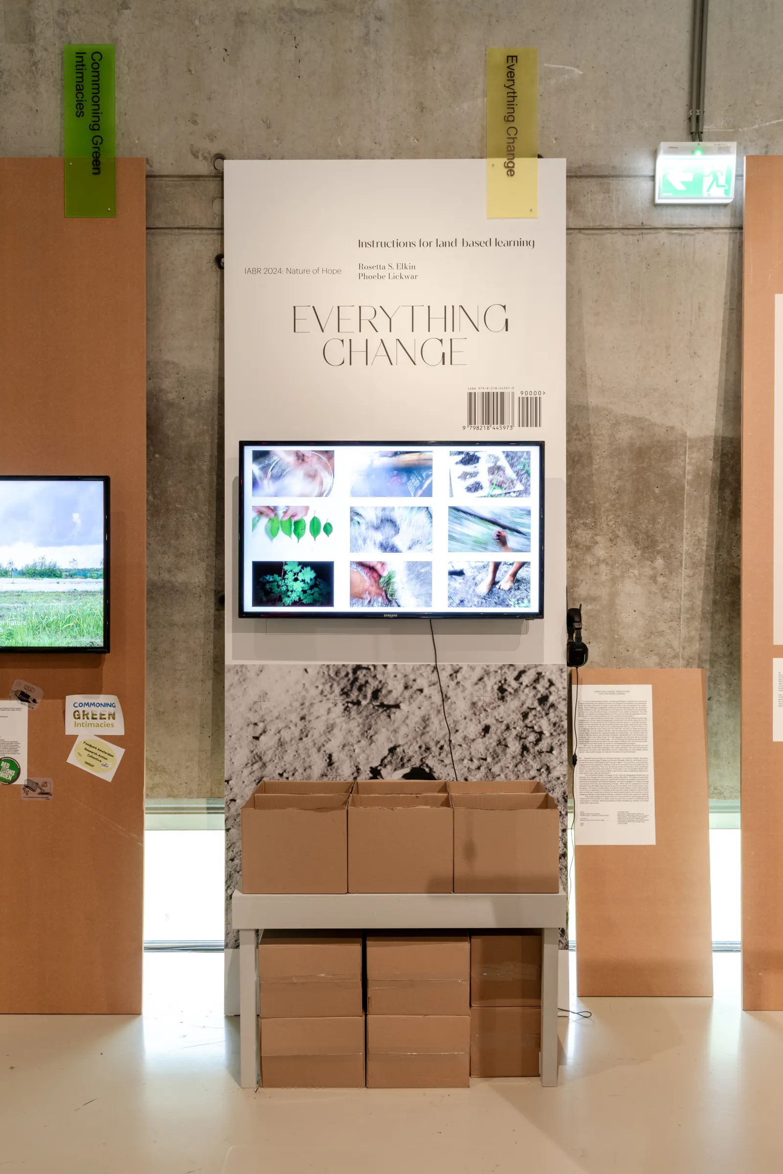 Everything Change exhibition Museum installation with video screen and box of instruction booklets
