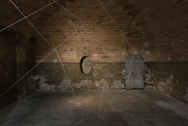 brick room with no windows criss-crossed by filaments of light