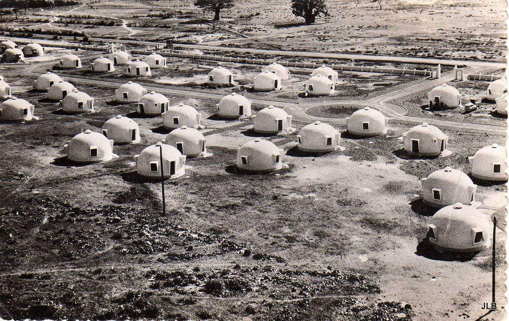 grassy field with many igloo-shaped white buildings