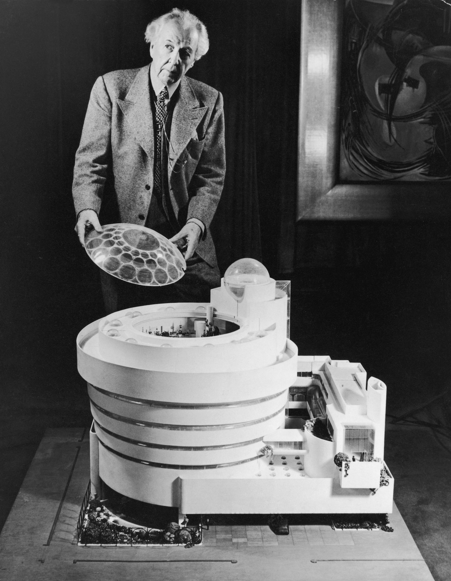 photo of Phillip Johnson with a model of the Guggenheim Museum