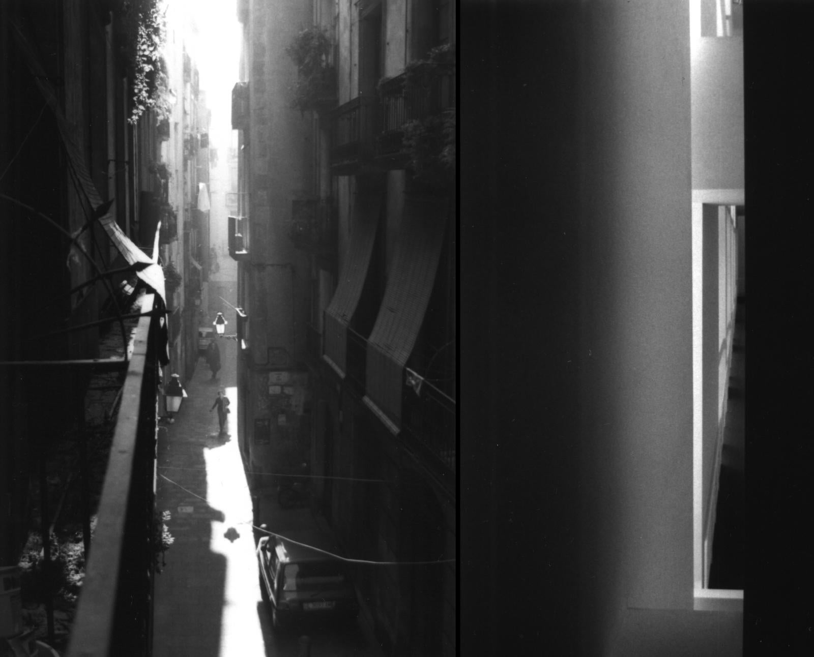 slightly blurred photo of a narrow alley with light filtering through it