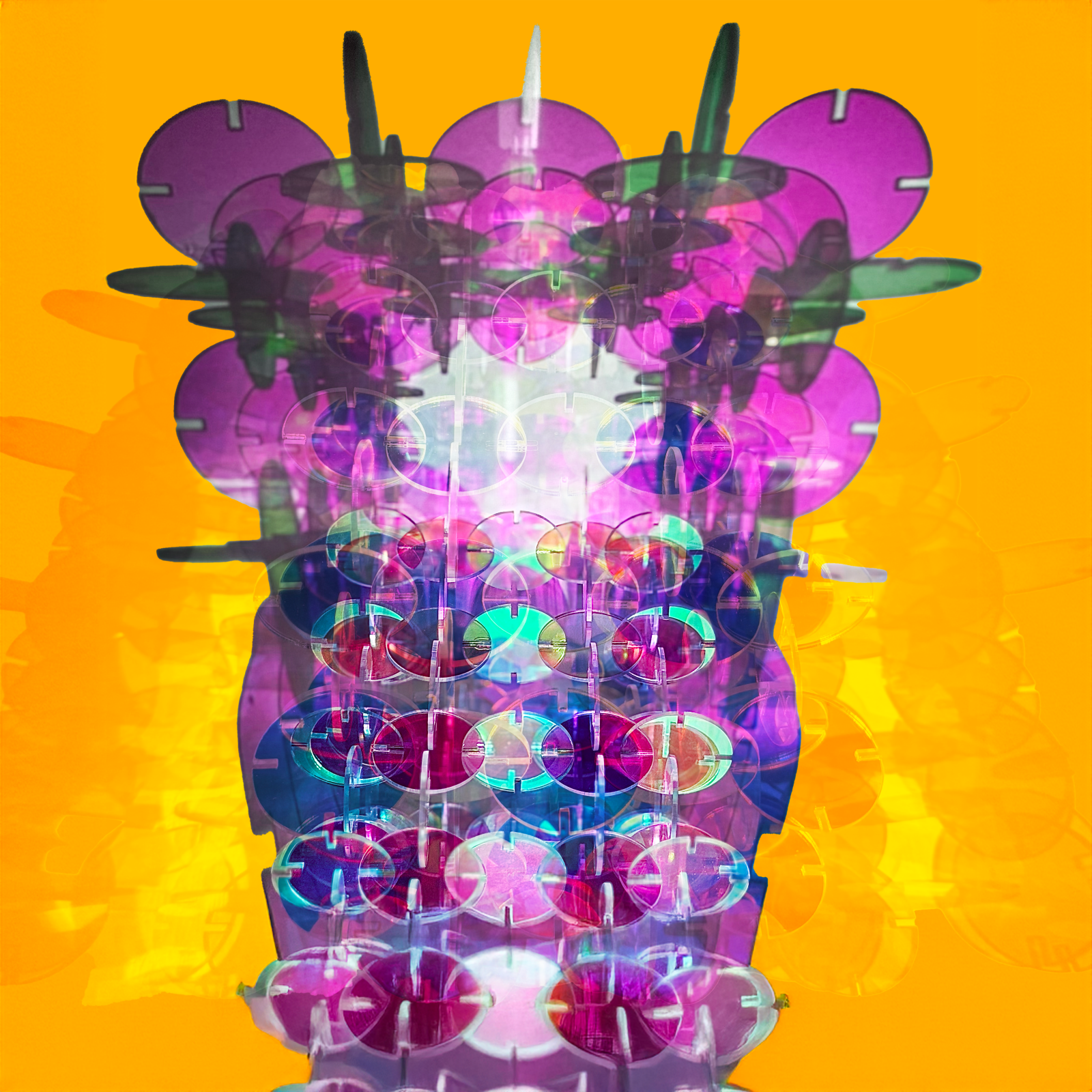 a reflective sculpture made of round interlocking dichroic acrylic pieces 