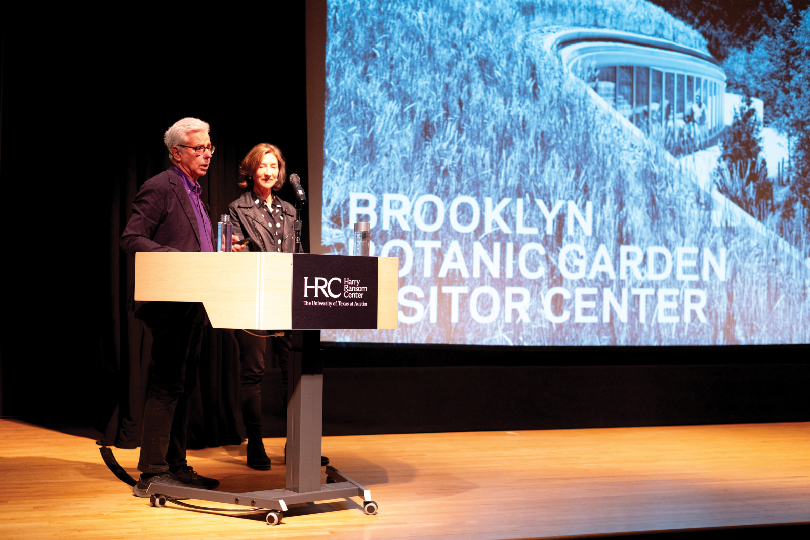 Lecturers Weiss Manfredi stand in front of projected slide of Brooklyn Botanic Garden