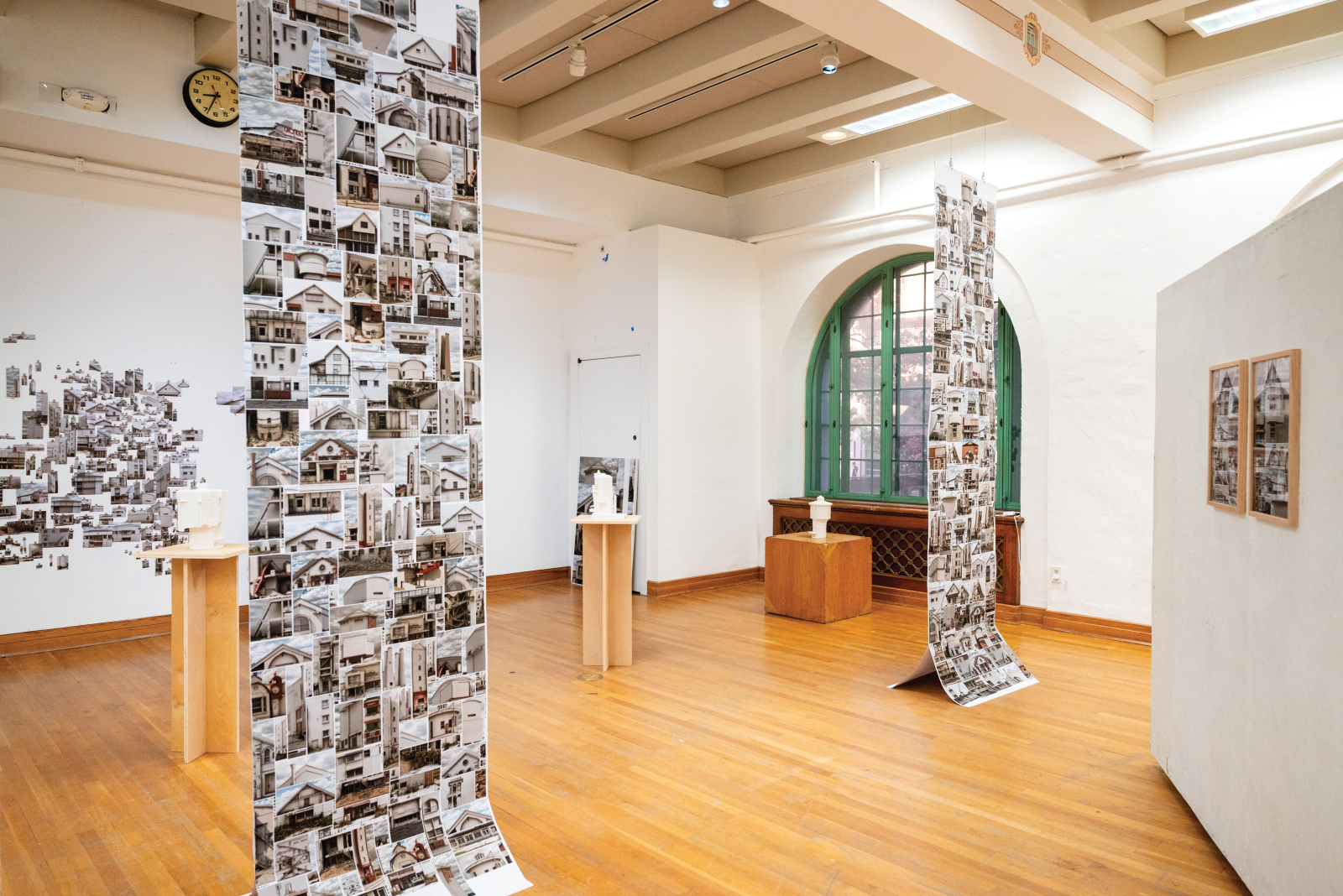 Images hang from banners for "Anomalies and Order" exhibition at Mebane Gallery