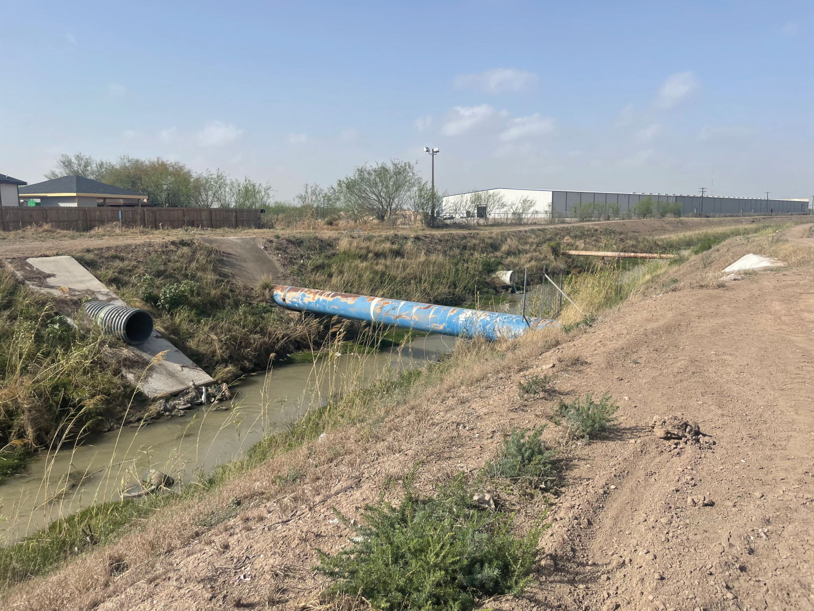 drainage ditch with sparse vegetation 