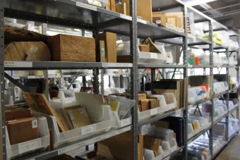 Material samples on display on a metal shelving system