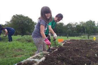 Children gardening in Dove Springs