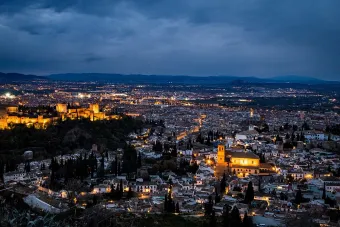 Nighttime view of a Spanish city from above.